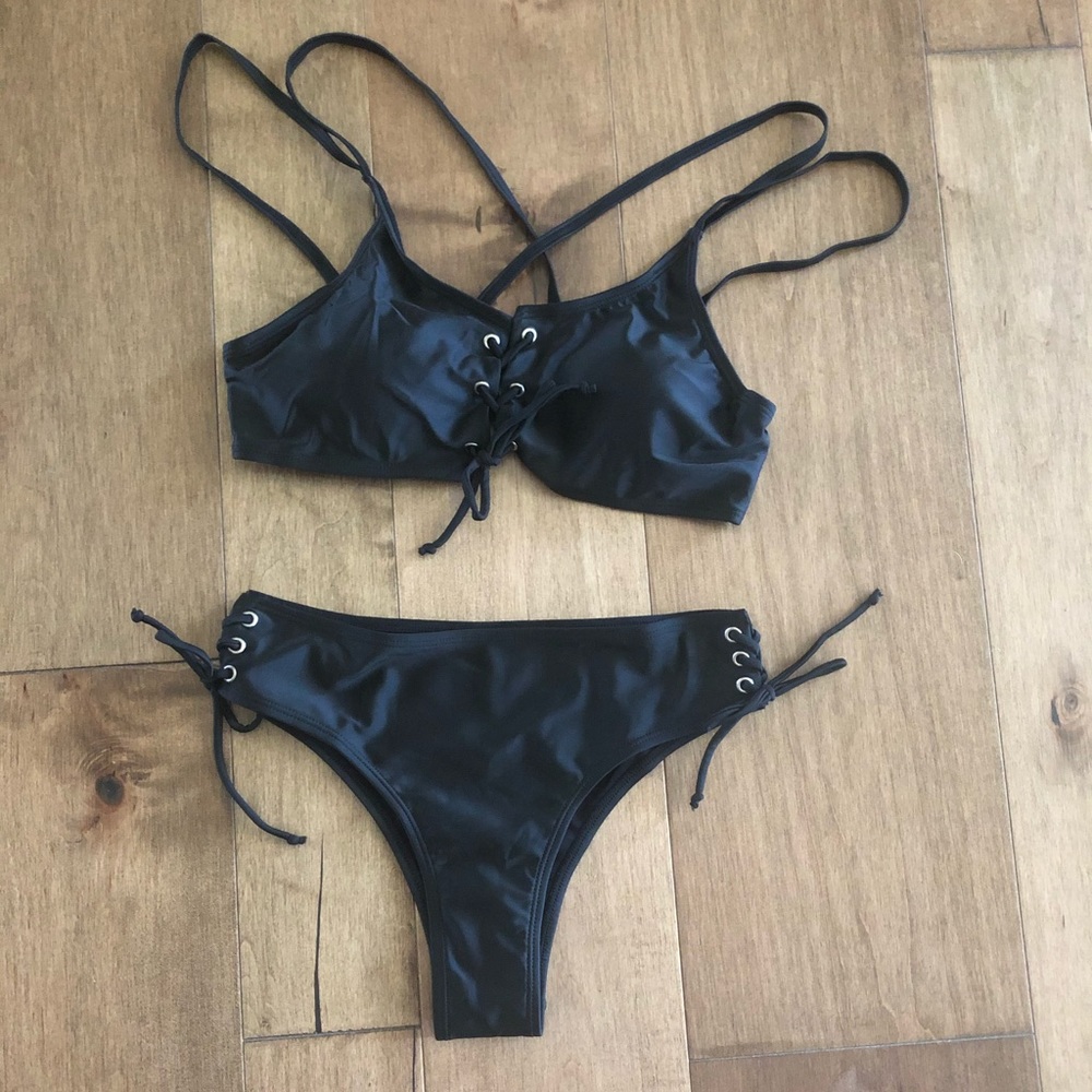 Brand new. Black 2 pc swim suit. Size 8.